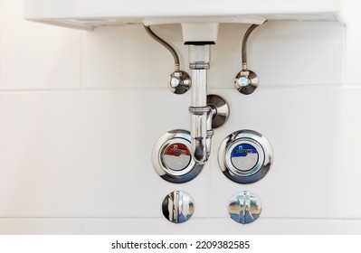 Sink Drain Pipe Or Sewer Stainless Steel Basin Siphon In Bathroom. Plumbing Accessories With Water Counter Meter Close Up.