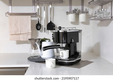 Sink with kitchen utensils and coffee maker