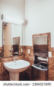 Sink, Mirror, Paper Towel Dispenser And Trash Can In Drug Testing Site Clinic Bathroom