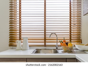 Sink In The Modern Kitchen, Windows Decorated With Wooden Blinds