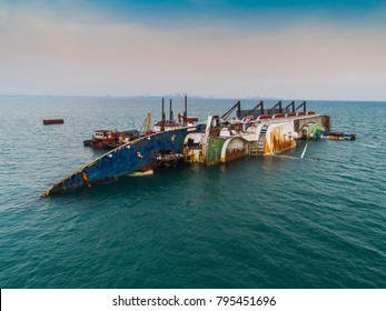 a sink passenger ship lie down in middle of the sea under cutting scrap iron, useless and wreckage junk ship for rid of detroy away from pollution  - Shutterstock ID 795451696