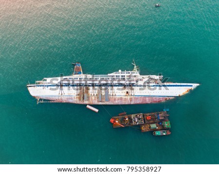 a sink passenger ship lie down in middle of the sea under cutting scrap iron, useless and wreckage junk ship for rid of detroy away from pollution 