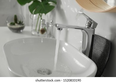 Sink With Running Water In Modern Bathroom