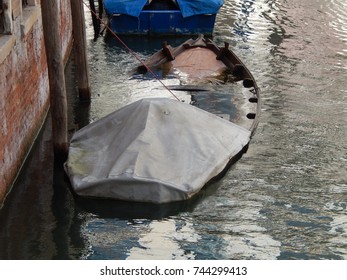 A Sinking Boat In Venice Italy