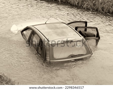 Sinking car in the river. Concept of auto car insurance.