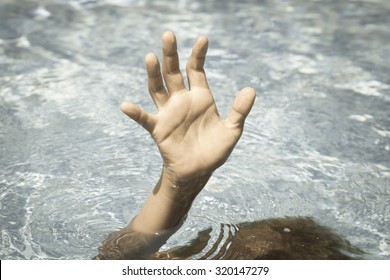 Sinking Person Calls For Help. Hand Drowning Man Sticking Out Of The Water.