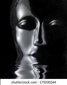 sinking translucent reflective human head made of glass on reflective water surface in black back