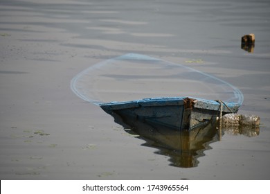 The Sinking Wooden Boat In The Lake