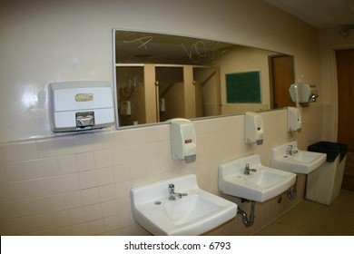 sinks and a mirror in a public washroom