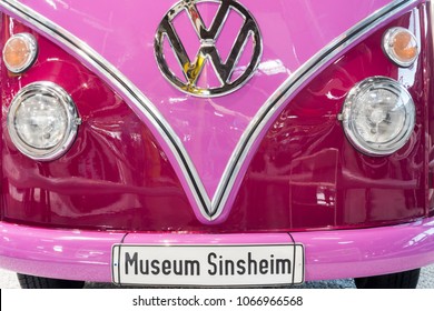 SINSHEIM, GERMANY - APRIL 8, 2018:
Front of a pink Volkswagen bus vintage car with inscribed license plate "Museum Sinsheim" and large VW logo in the technic museum Sinsheim