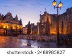 Sint Veerleplein square and Gravensteen castle or Counts of Flanders, medieval fortress, Ghent, Belgium. Scenic view of historic landmarks, old city architecture at twilight, outdoor travel background