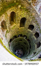 SINTRA, PORTUGAL - APRIL 21, 2019: View from top downward of spiral staircase of historical Initiation well in Quinta da Regaleira