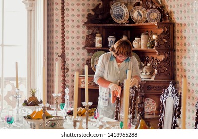 SINTRA, PORTUGAL: Cleaning Woman Making Nice Interior And Utensils Of Dinning Room Of 19th Century Pena Palace On 16 May, 2019. Historical Castle And An UNESCO World Heritage Site.