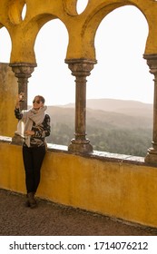 Sintra/Portugal- October, 2019: A Tourist Takes A Selfie At Golden Hour Over At The Palace Of Pena. 