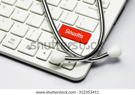 Sinusitis text, stethoscope lying down on the computer keyboard