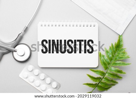 Sinusitis word on notebook,stethoscope and green plant