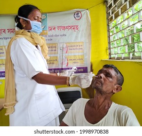 Sipajhar, Assam, India, June 29,2021: A Health Care Provider Collecting Nasal Swab From An Adult Male During His Regular Visit To A Rural Medical Facility In Assam