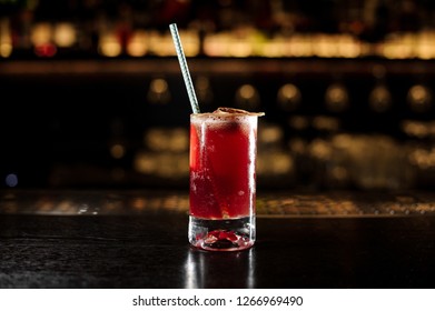 Sippy Cup Cocktail In The Glass Decorated With A One Dried Orange With Tubule On The Bar Counter