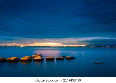 Siracusa, Italy - March 2022: Long exposure to the sea at sunset