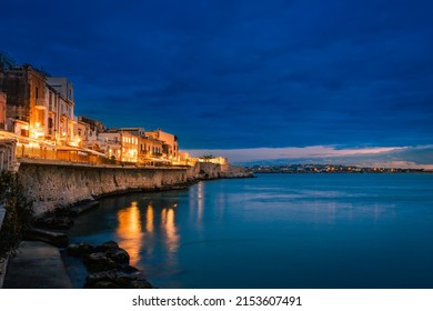 Siracusa, Italy - March 2022: Long exposure of Ortigia at sunset on the sea