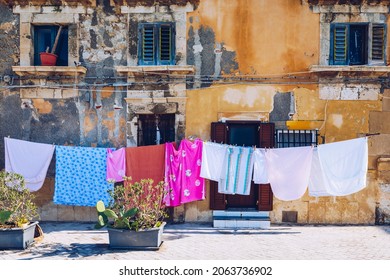 Siracusa (Syracuse) in a sunny summer day. Sicily, Italy. The clothes being dried in the narrow street of the famous historic town Syracuse, Sicily.