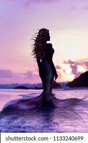 Siren woman on the sunset beach