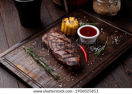 Sirloin grilled corn  on a dark wooden board, recipe magazine photo Stock foto © 