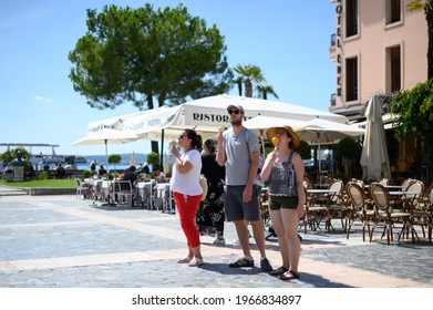 Sirmione Italy 08.05.2020: Three Tourists Eating Italian Ice Cream