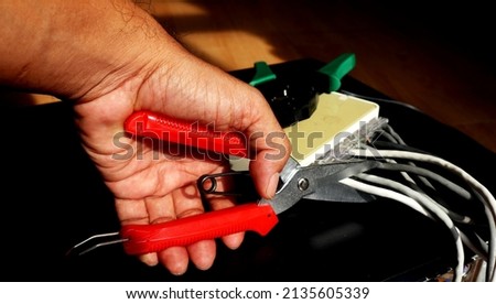 
Sissors cutting a network cable. Wireless concept. 	