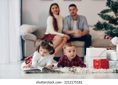 Sister And Brother Have Fun. Beautiful Family Celebrates New Year And Christmas Indoors At Home.