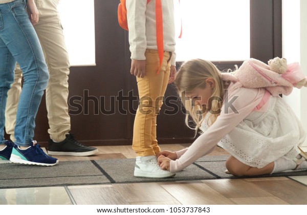 Sister Helping Brother Tie Shoes 