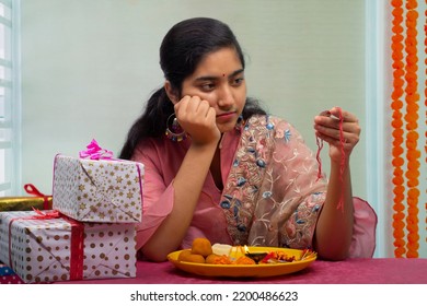 Sister With Pooja Plate And Rakhi Waiting Alone For Her Brother On The Occasion Of Raksha Bandhan