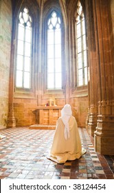 Sister praying into the Abbey of Mont Saint Michel, France