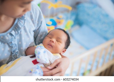 Sister Takecare Asian New Born Baby To Sleep In Thr Cradle