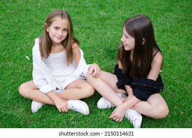 sisterhood. two sisters or friends spending time outdoors on sunny summer day. bff, sibling, girlfriend. millennial teen.