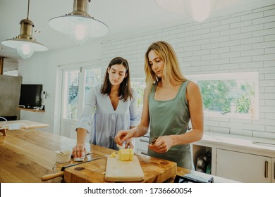 Sisters Cleaning Counter Top In The Kitchen Together