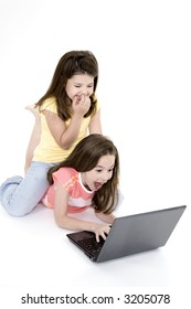 Sisters playing on a laptop computer on a white background