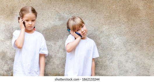 Sisters, two little girls, young children talking on their smartphones, kids speaking through their own modern mobile phones. Telecommunication, contact, cell phone usage, tech savvy kids concept - Shutterstock ID 1862133244