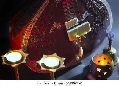 Sitar, a String Traditional Indian Musical Instrument, close-up, blue lens effect. dark background with incense smoke. Evening of ethnic oriental music. Indian Raga