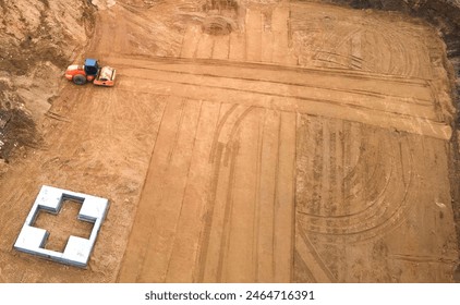 Сonstruction site, aerial view. Vibration road roller leveling the ground for construct of foundation for building. Soil Compactor compresses soil for formwork, housing. Vibro Roller Soil Compactor. - Powered by Shutterstock