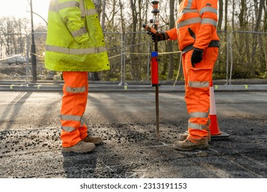 Site engineer surveyor and site manager discussing plan of works on construction site during new road construction - Shutterstock ID 2313191153