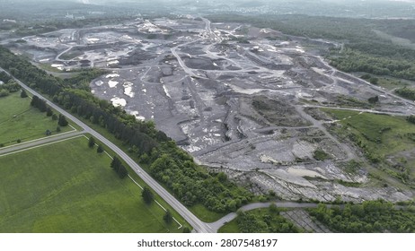 A site established for mining is stretched across the land below.