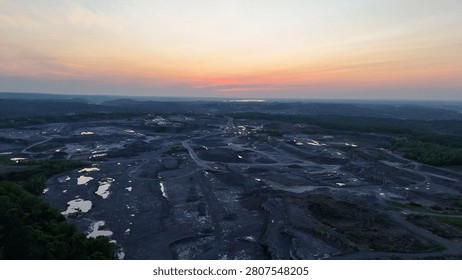 A site established for mining is stretched across the land below.