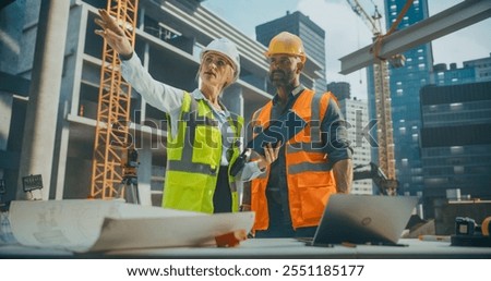 Site Manager Talking with General Construction Operative at a Residential Building Construction Area. Female and Male Employees Using a Tablet Computer to Oversee the Project Requirements