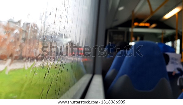 Sitting in\
the bus while raining outside in the\
city