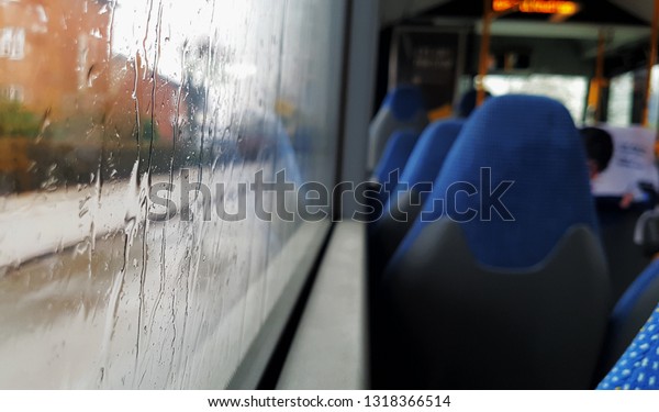 Sitting in
the bus while raining outside in the
city