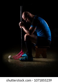 Sitting Floorball Player. Studio Photography