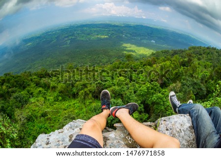 Sitting hanging on a high cliff The bottom is a hot and humid aunt. To the horizon