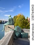 Sitting Helvetia statue on the river Rhine in Basel, Switzerland