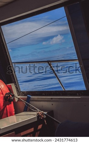 Sitting inside a fishing boat, looking out. Calm morning water on the ocean in Kauai, Hawaii. Vacation time and fishing trip, tourists on vacation photos and ideas for travel to Hawaii icon